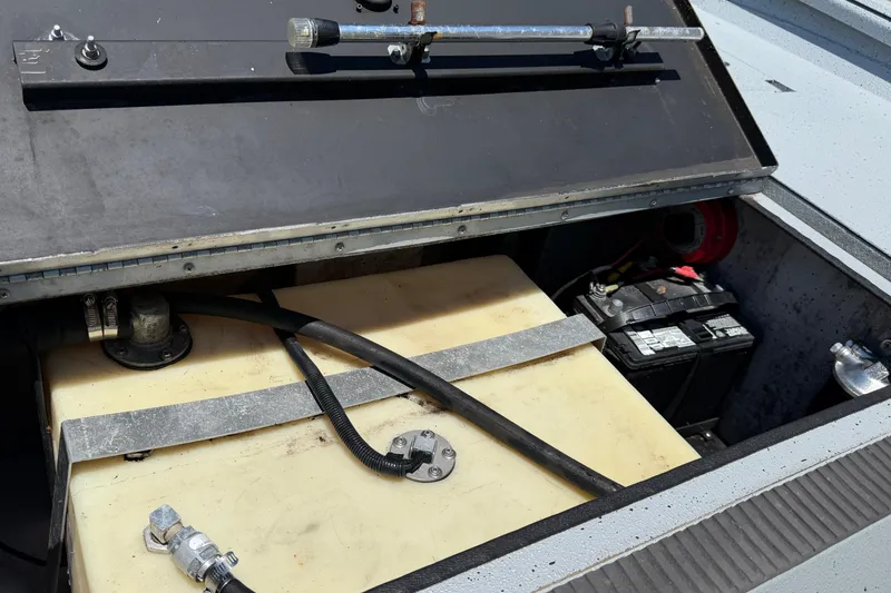 Slide: The Image of 2018 Excel 203 Bay Pro boat battery and fuel tank compartment. - 14