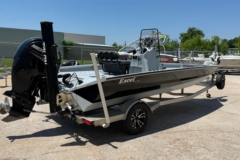 Slide: The Image of 2018 Excel 203 Bay Pro boat on trailer, featuring a Mercury outboard motor. - 5