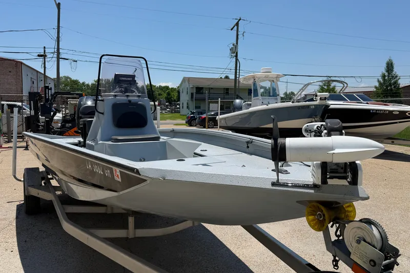 Slide: The Image of 2018 Excel 203 Bay Pro boat on trailer, parked outdoors under clear sky. - 8