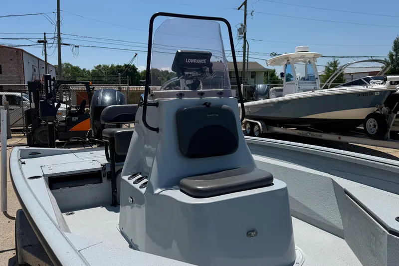 Slide: The Image of 2018 Excel 203 Bay Pro boat with console and seating, parked in a marina. - 9