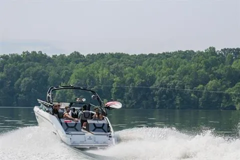 Slide: The Image of 2026 Yamaha Boats 222XD cruising on a lake with lush green forest backdrop. - 12