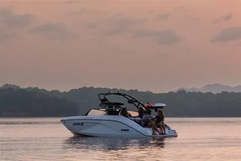 Slide: The Image of 2026 Yamaha Boats 222XD cruising on a serene lake at sunset. - 15