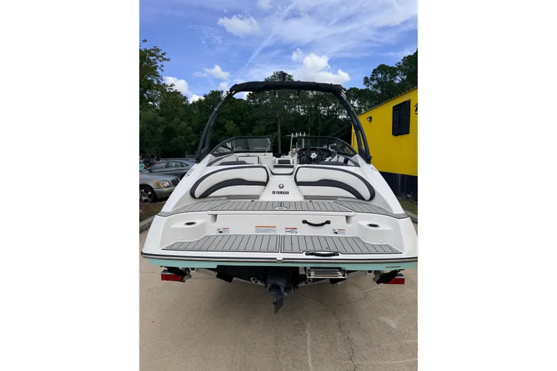 Slide: The Image of Rear view of a 2026 Yamaha AR195 boat in a parking lot. - 5