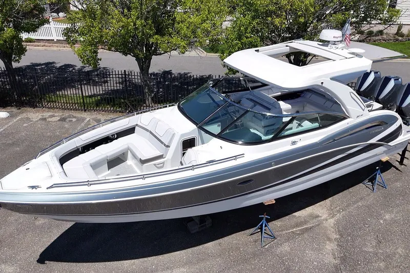 Slide: The Image of 2023 Formula 350 Crossover Bowrider OB, sleek design, parked on stands, outdoor setting. - 10