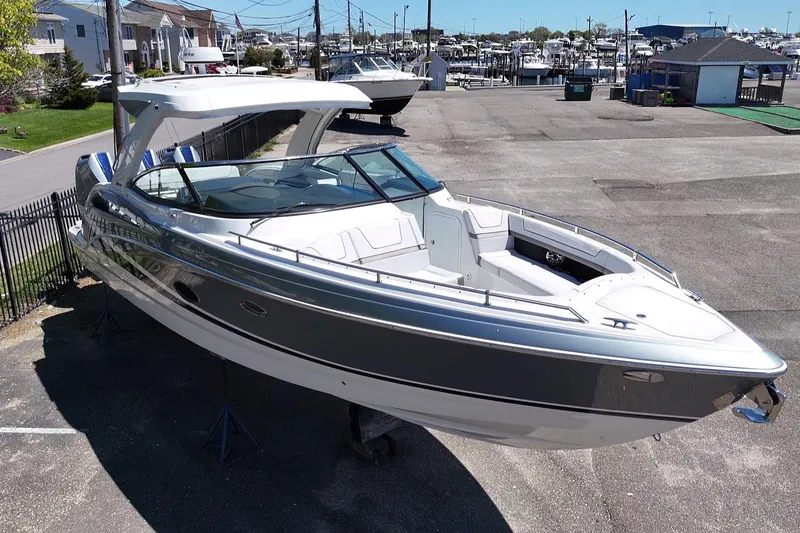 Slide: The Image of 2023 Formula 350 Crossover Bowrider OB in marina, showcasing sleek design and spacious seating. - 3