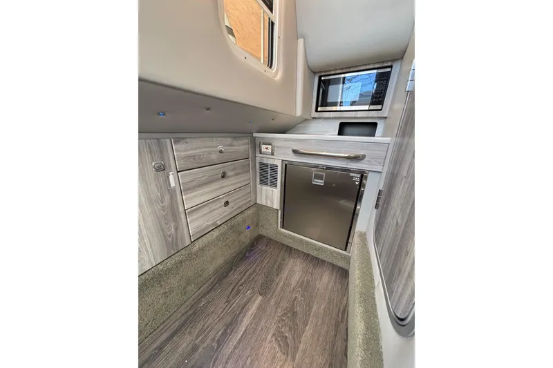 Slide: The Image of 2023 Formula 350 Crossover Bowrider OB interior with modern cabinetry and appliances. - 40