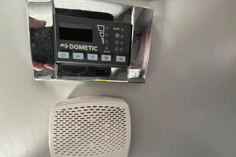 Slide: The Image of Dometic control panel and speaker in 2023 Formula 350 Crossover Bowrider OB boat. - 42