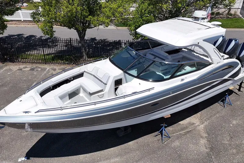 Slide: The Image of 2023 Formula 350 Crossover Bowrider OB, sleek design, parked outdoors on stands. - 8