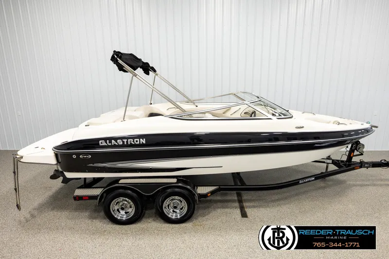 The Image of 2007 Glastron GXL 205 boat on trailer in showroom, side view. - 1