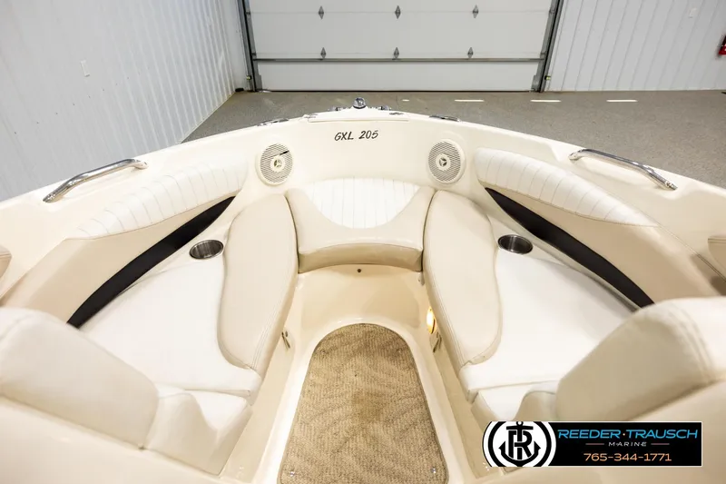 Slide: The Image of 2007 Glastron GXL 205 boat interior with beige seating and cup holders. - 15