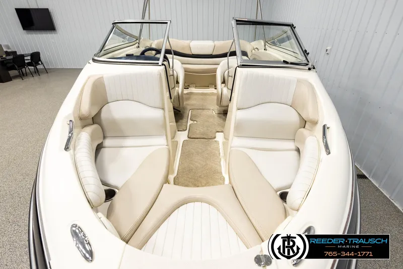 Slide: The Image of 2007 Glastron GXL 205 boat interior with beige seating and carpeted flooring. - 16