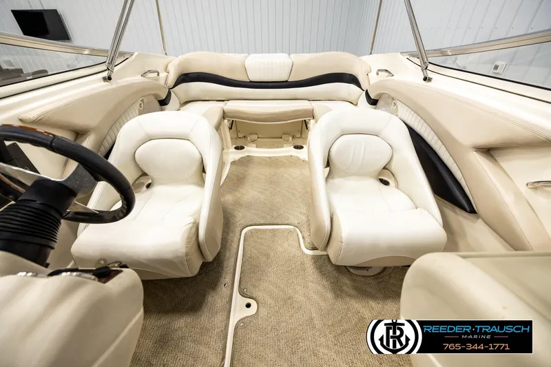 Slide: The Image of 2007 Glastron GXL 205 boat interior with beige seating and steering wheel. - 17
