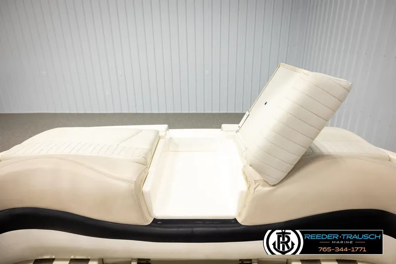 Slide: The Image of 2007 Glastron GXL 205 boat seat with white upholstery in a showroom setting. - 27