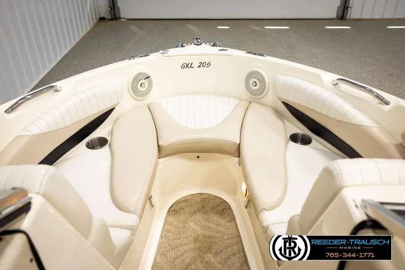 Slide: The Image of 2007 Glastron GXL 205 boat interior with beige seating and cup holders. - 29
