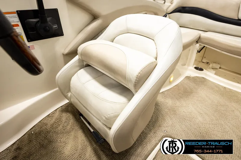 Slide: The Image of 2007 Glastron GXL 205 boat interior with plush white seating and carpeted flooring. - 32