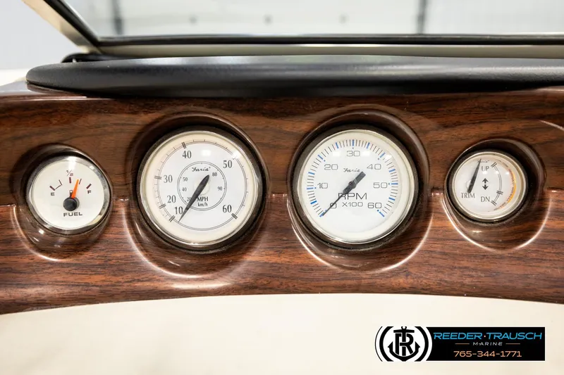 Slide: The Image of Dashboard gauges of a 2007 Glastron GXL 205 boat, featuring speedometer and fuel indicators. - 36