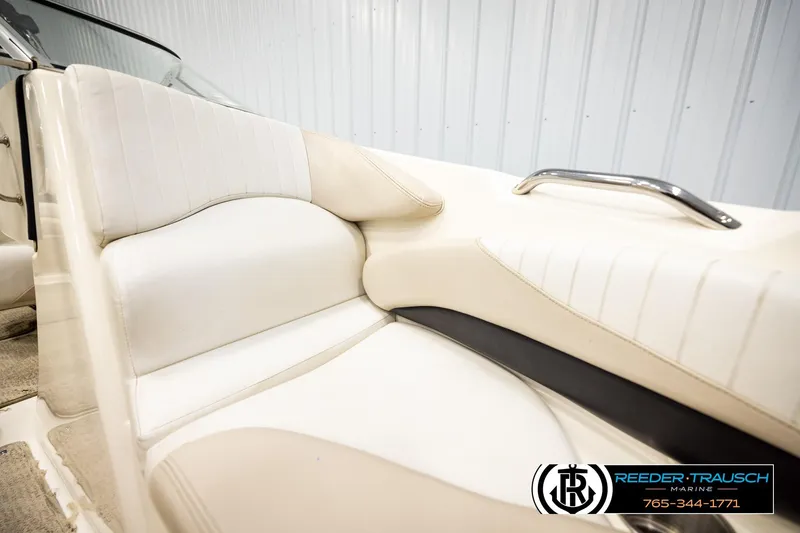 Slide: The Image of 2007 Glastron GXL 205 boat interior with white leather seating and chrome handle. - 40