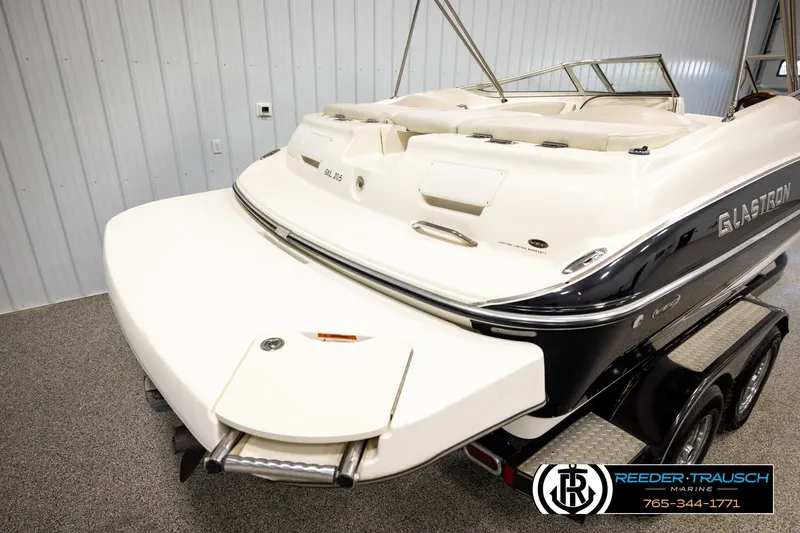 Slide: The Image of 2007 Glastron GXL 205 boat in showroom, featuring sleek design and swim platform. - 47