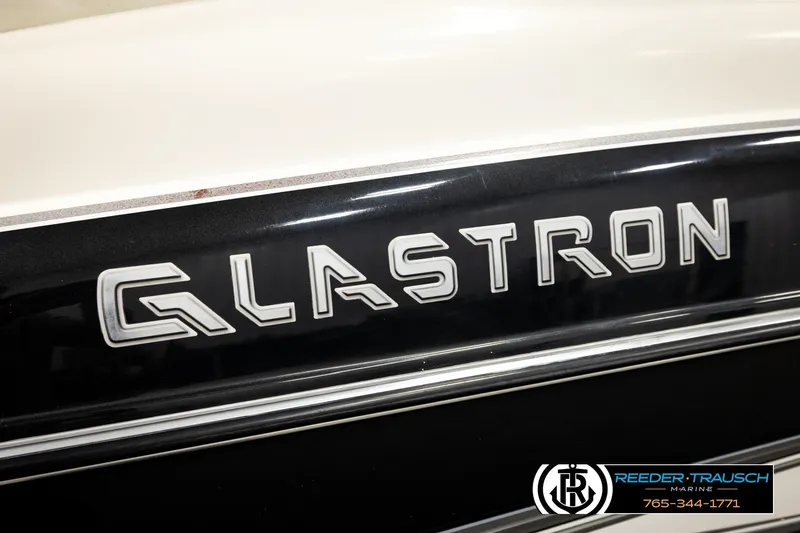 Slide: The Image of 2007 Glastron GXL 205 boat logo on black and white surface. - 52