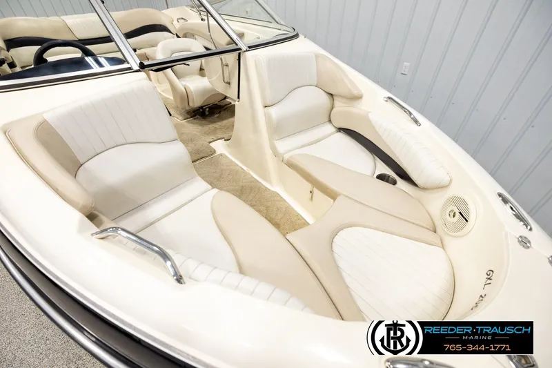 Slide: The Image of 2007 Glastron GXL 205 boat interior with beige and white seating, showcasing spacious design. - 9