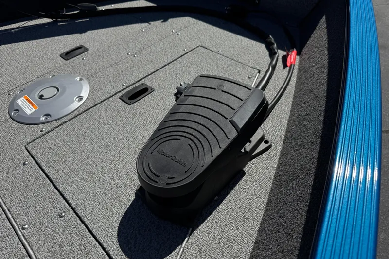 Slide: The Image of 2025 Lund 1650 Angler SS boat deck with foot pedal and blue trim. - 11