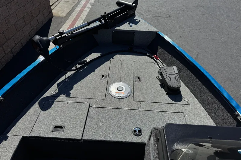 Slide: The Image of 2025 Lund 1650 Angler SS boat deck with trolling motor and storage compartments. - 12