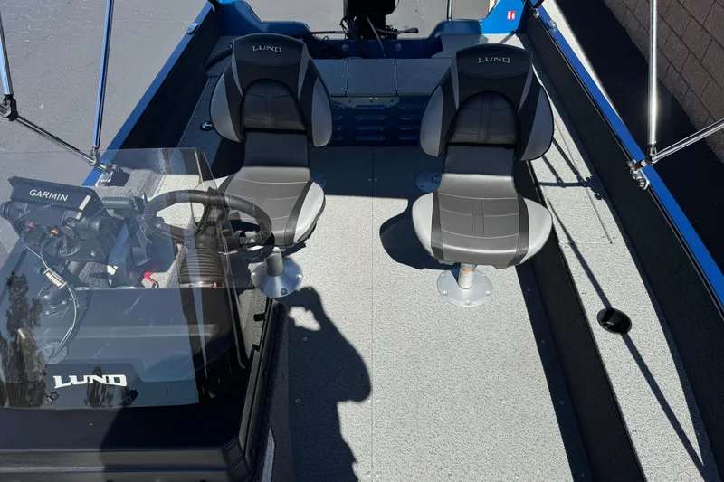 Slide: The Image of 2025 Lund 1650 Angler SS boat interior with two seats and Garmin equipment. - 14