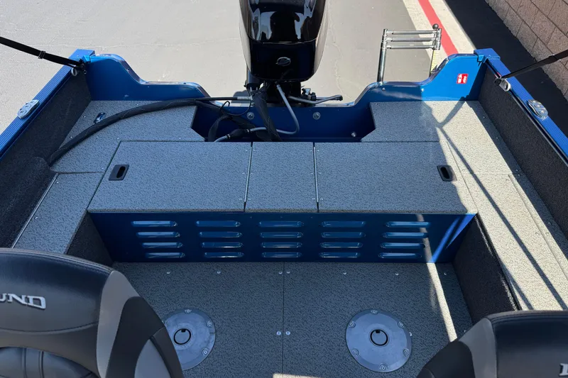 Slide: The Image of 2025 Lund 1650 Angler SS boat interior with motor and seating area. - 15