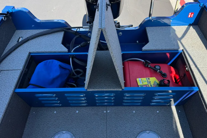 Slide: The Image of 2025 Lund 1650 Angler SS boat storage compartments with fuel tank and gear. - 16