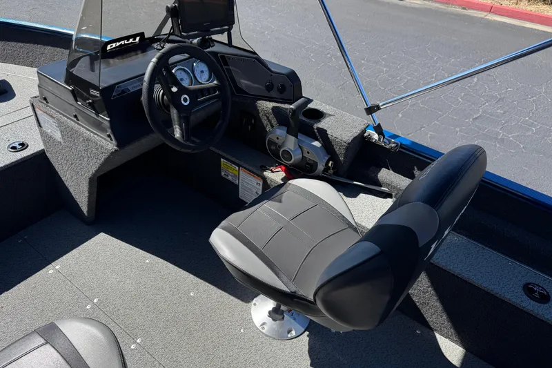 Slide: The Image of 2025 Lund 1650 Angler SS boat interior with steering wheel and seat. - 19