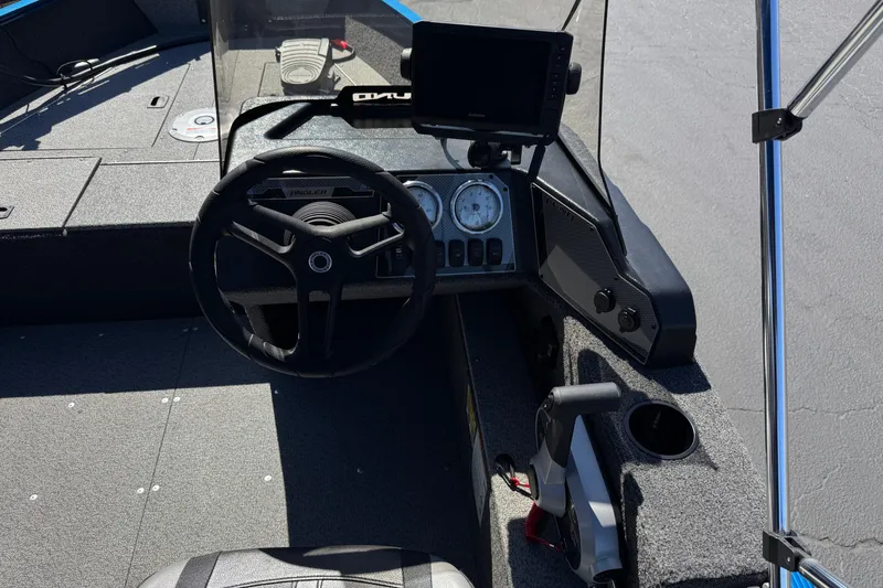 Slide: The Image of 2025 Lund 1650 Angler SS boat dashboard with steering wheel and electronic display. - 20
