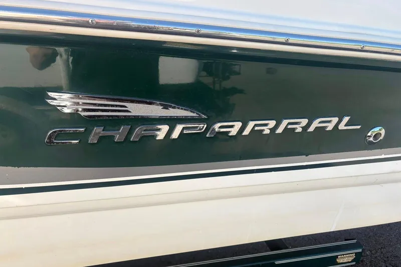 Slide: The Image of 2000 Chaparral Sunesta 232 boat logo on green and white hull. - 2