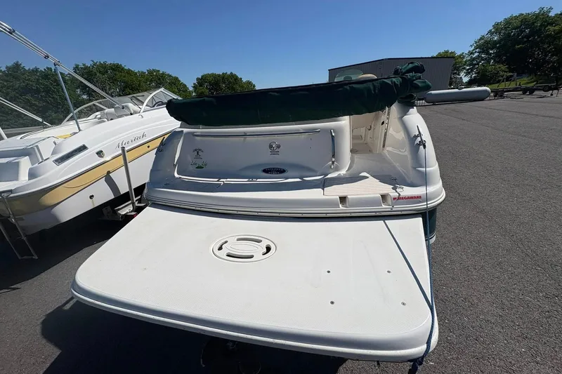 Slide: The Image of 2000 Chaparral Sunesta 232 boat with swim platform, parked outdoors on a sunny day. - 4