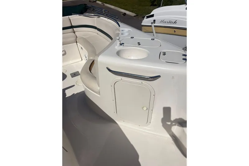Slide: The Image of 2000 Chaparral Sunesta 232 boat interior with seating and storage compartments. - 7