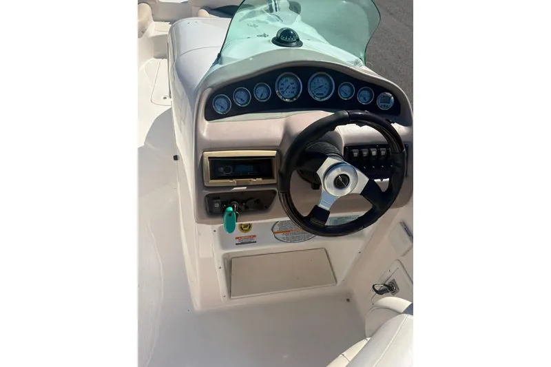 Slide: The Image of 2000 Chaparral Sunesta 232 boat dashboard with steering wheel and instrument panel. - 8