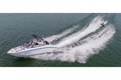 Slide: The Image of 2026 Yamaha Boats AR190 speeding on water with a person on a jet ski behind. - 9