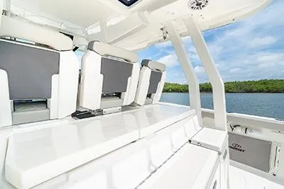 Slide: The Image of 2026 Pursuit S 358 Sport boat interior with sleek seating and scenic water view. - 10