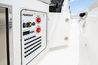 Slide: The Image of 2026 Pursuit S 358 Sport boat control panel with switches and indicators. - 15