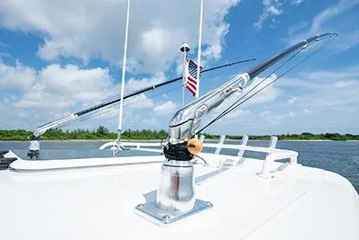 Slide: The Image of 2026 Pursuit S 358 Sport boat deck with fishing rods and American flag. - 19