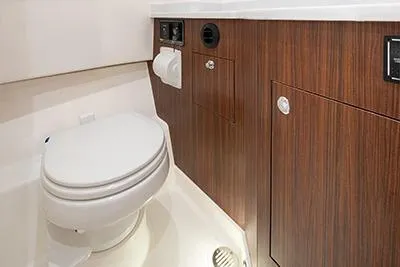 Slide: The Image of 2026 Pursuit S 358 Sport boat bathroom with wood cabinetry and modern fixtures. - 21