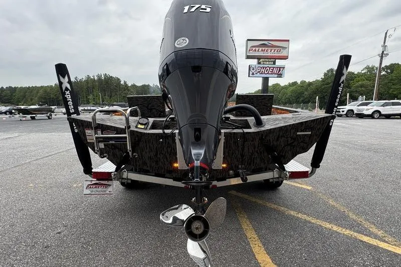 Slide: The Image of 2026 Xpress H22B Bay boat with powerful 175 engine, parked on trailer. - 13
