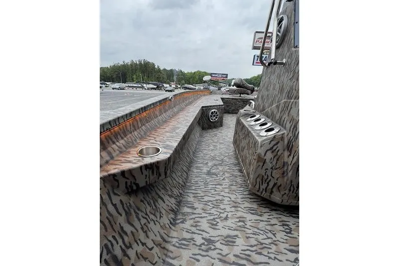 Slide: The Image of 2026 Xpress H22B Bay boat interior with camo design and cup holders. - 17