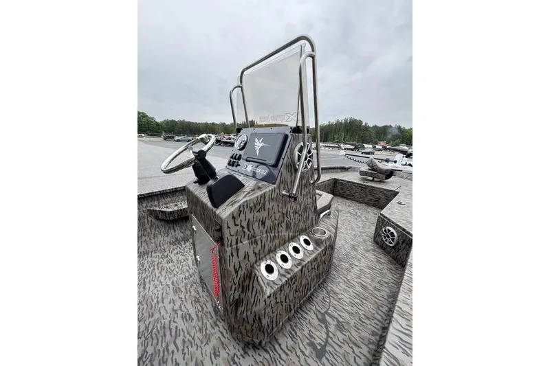 Slide: The Image of 2026 Xpress H22B Bay boat console with camouflage design and modern controls. - 9