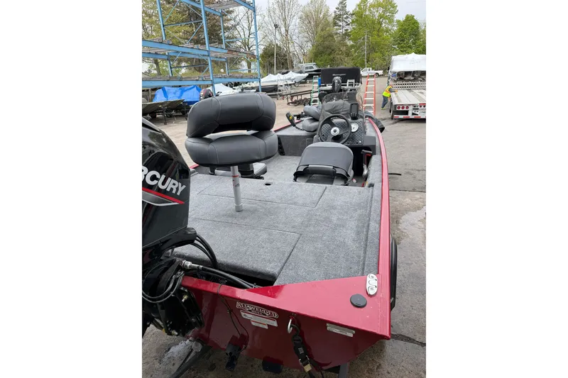 Slide: The Image of 2024 Tracker Bass Tracker Classic XL boat with Mercury engine, featuring spacious seating and controls. - 4