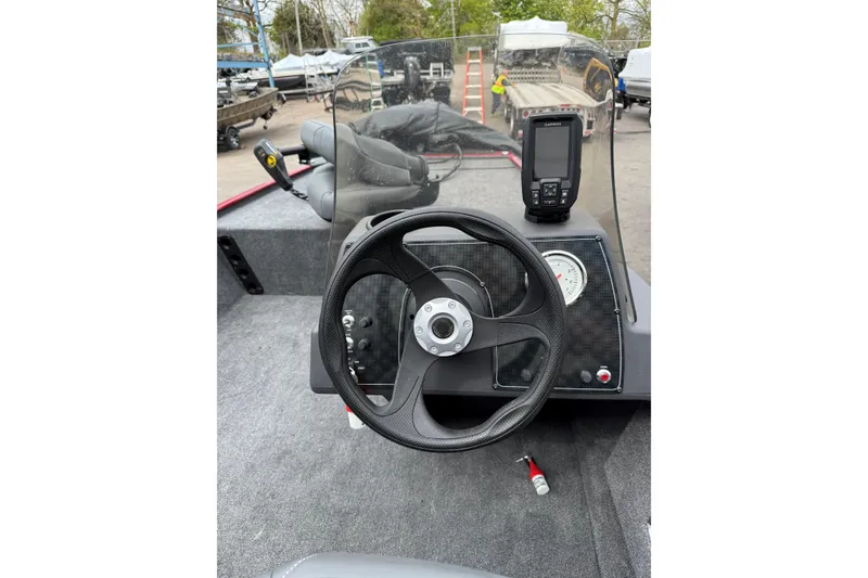 Slide: The Image of 2024 Tracker Bass Tracker Classic XL boat dashboard with steering wheel and navigation system. - 5