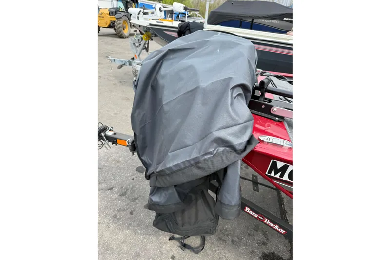 Slide: The Image of 2024 Tracker Bass Tracker Classic XL with covered outboard motor in a parking lot. - 7