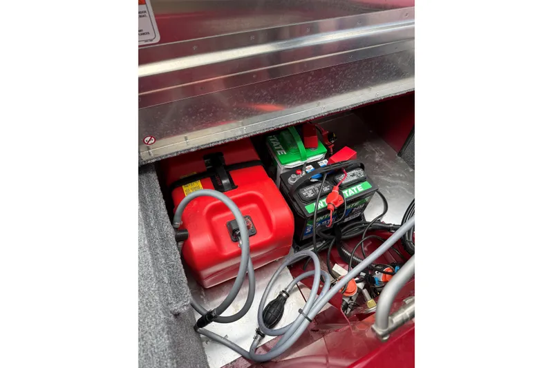 Slide: The Image of 2024 Tracker Bass Tracker Classic XL battery and fuel compartment with wiring and red fuel tank. - 8