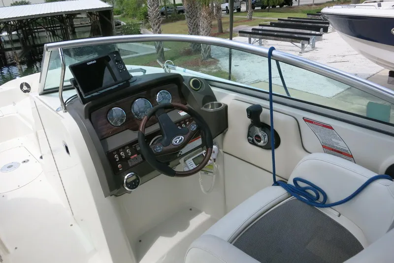 Slide: The Image of Interior view of a 2008 Sea Ray 260 Sundeck boat cockpit with steering wheel and controls. - 10