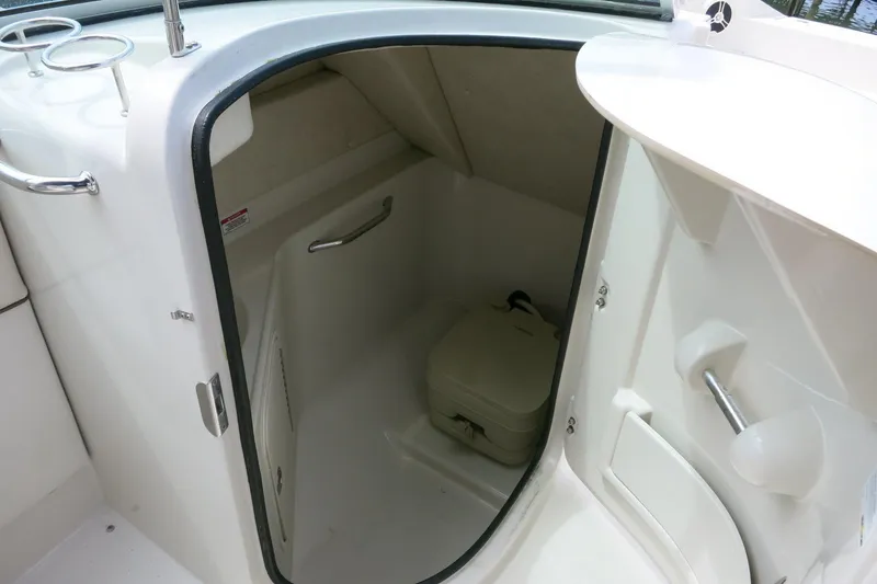 Slide: The Image of 2008 Sea Ray 260 Sundeck boat interior with compact restroom compartment. - 11