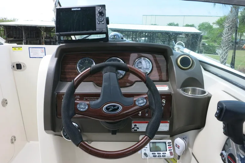 Slide: The Image of Dashboard of a 2008 Sea Ray 260 Sundeck boat with steering wheel and navigation equipment. - 14